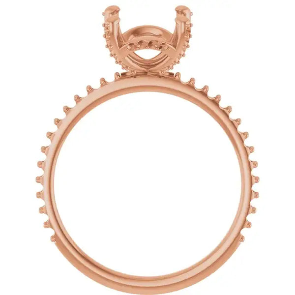 Rose gold engagement ring setting with oval stone holder and hidden halo design featuring decorative prongs around the band.