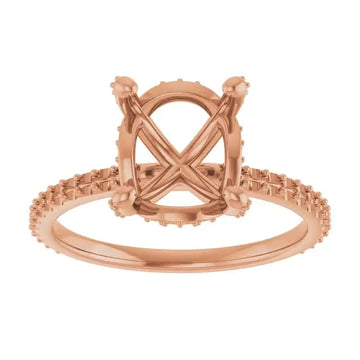 Rose gold engagement ring setting with oval stone holder, hidden halo design, and diamond accents along the band.