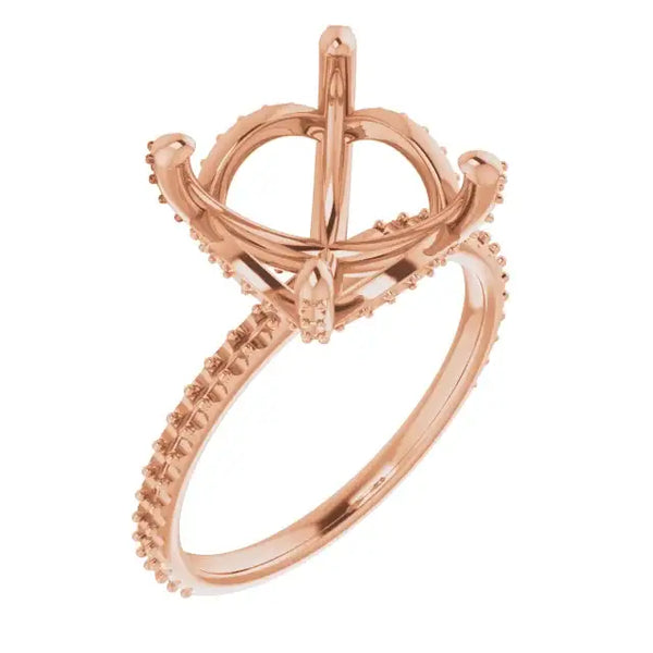 Rose gold ring setting with halo design and cushion stone mounting, featuring accent stones on band.
