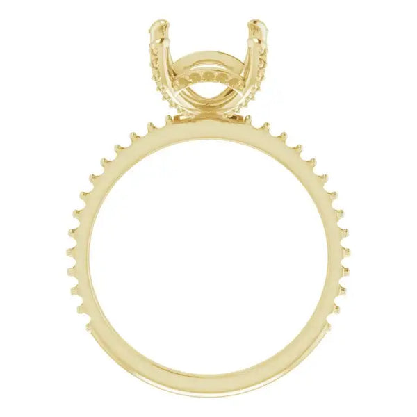 Yellow gold engagement ring setting with hidden halo design and prong head for emerald stone.