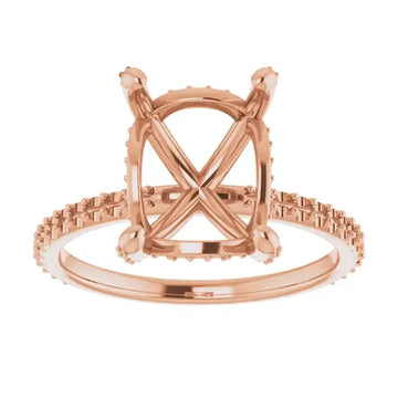 Rose gold engagement ring setting with cushion-shaped center stone mounting and hidden halo diamond accents along the band.