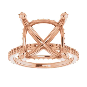 Rose gold engagement ring setting with square stone holder, decorative halo, and crossover band design.