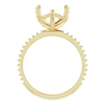 Gold engagement ring setting with four-prong head and halo of small stones around the band.