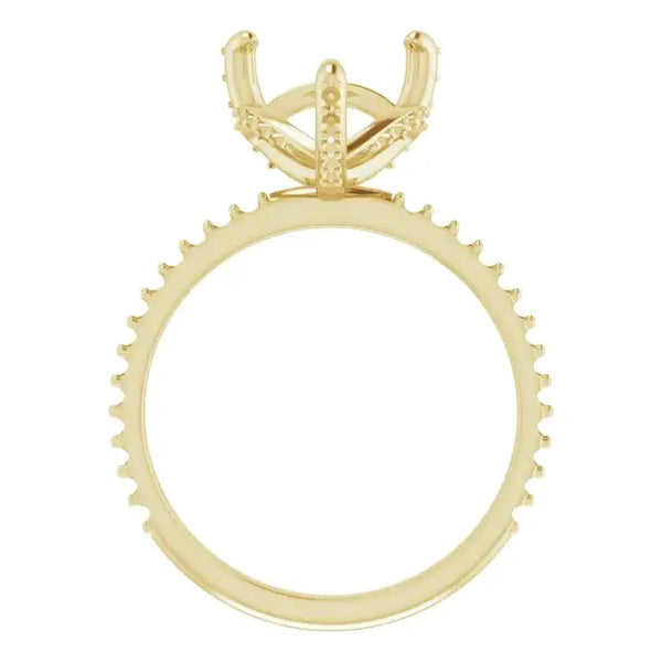 Gold engagement ring setting with four-prong head and halo of small stones around the band.