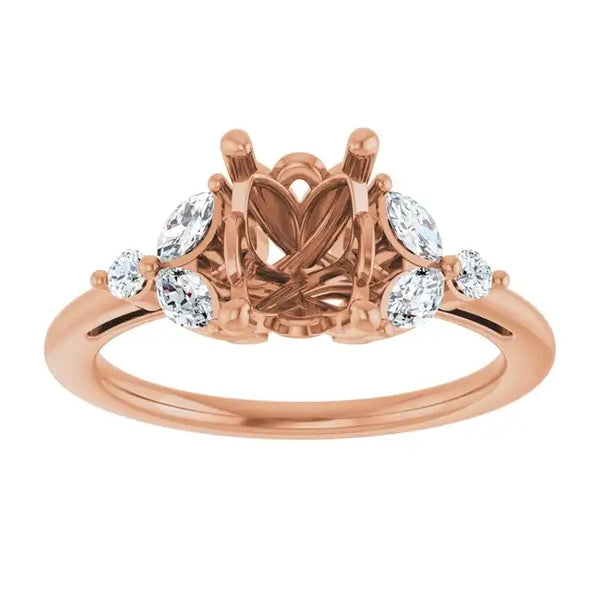 Rose gold engagement ring setting with oval lab-grown diamonds flanking an empty emerald-cut center stone.