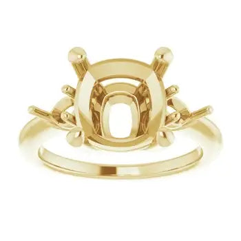 Gold engagement ring setting with cushion stone mounting and decorative side details.