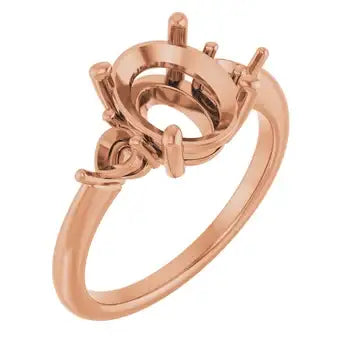 Rose gold engagement ring setting with oval stone mount and decorative side accents.