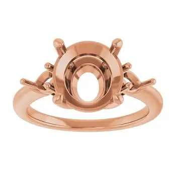 Rose gold engagement ring setting with oval stone cup and decorative side accents.