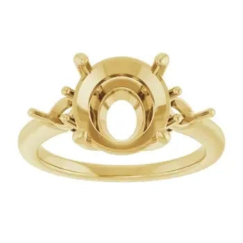 Gold engagement ring setting with oval center stone mounting and decorative side details.