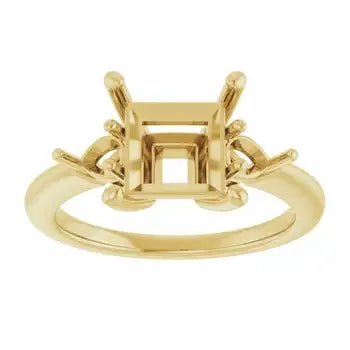 Gold engagement ring setting with square stone holder and decorative side accents.