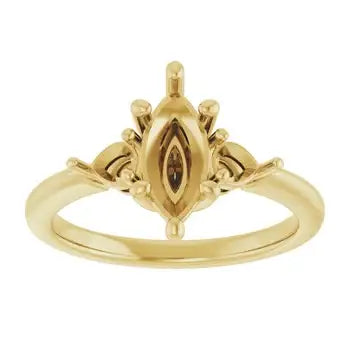 Gold engagement ring setting with marquise-shaped center stone and decorative side details.