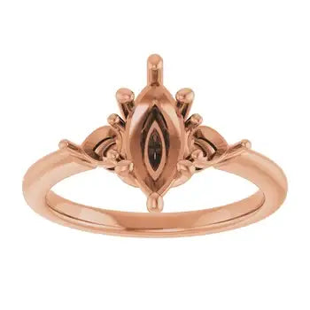 Rose gold engagement ring setting with marquise-shaped stone center and ornamental side detailing.