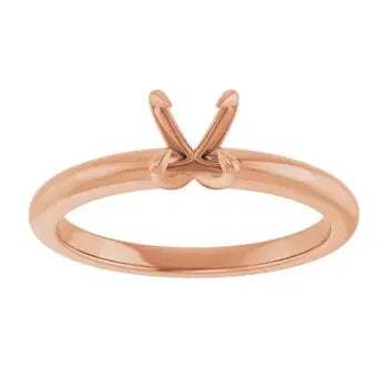 Rose gold solitaire engagement ring setting with V-shaped prongs for round stone, displayed on white background.