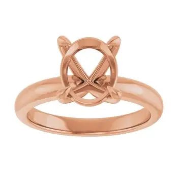 Rose gold solitaire engagement ring setting with oval stone mounting and decorative side details.