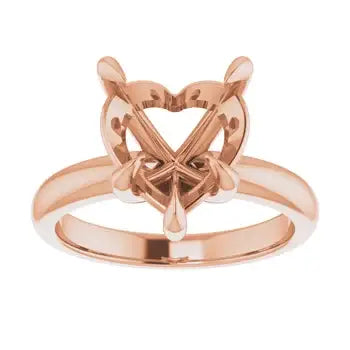 Rose gold engagement ring setting with heart-shaped stone holder and decorative openwork band.