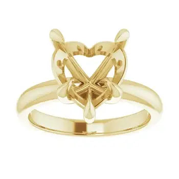 Gold solitaire engagement ring setting with ornate heart-shaped stone holder and decorative side details.