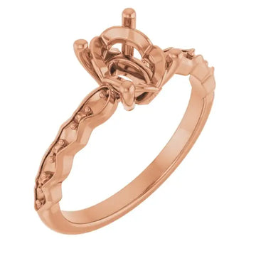 Rose gold engagement ring setting with ornate marquise-shaped stone holder and decorative scrollwork band.