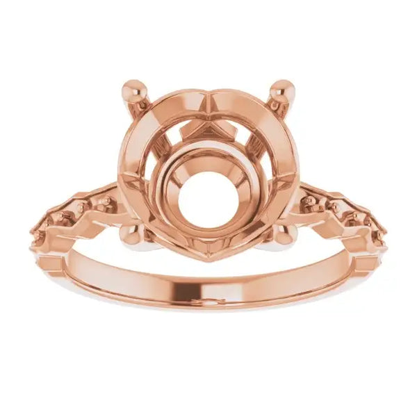 Rose gold engagement ring setting with French-set accents and round stone center mount, shown from front view.