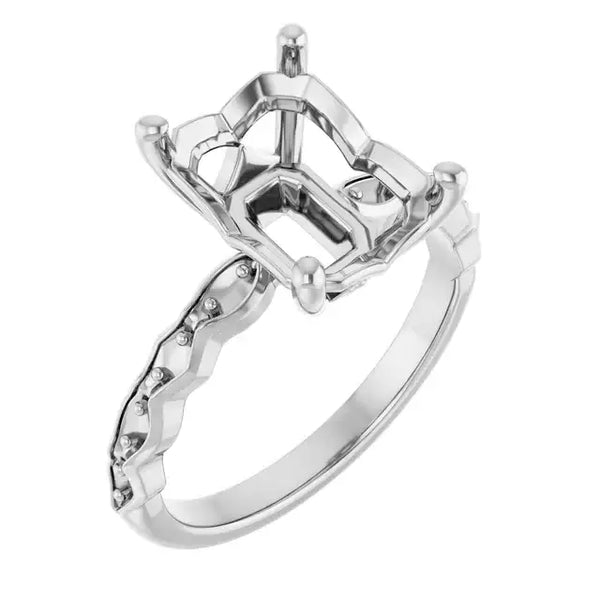 White metal engagement ring setting with French-set diamonds on band and empty emerald-cut stone holder on top.