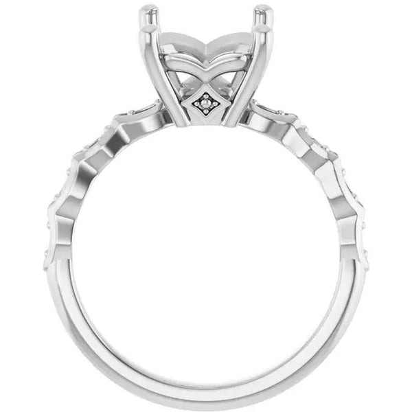 White metal engagement ring setting with ornate four-prong head and textured band, sized for emerald stone.