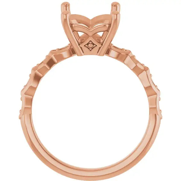 Rose gold engagement ring setting with French-set diamonds along band and geometric prong head for emerald stone.