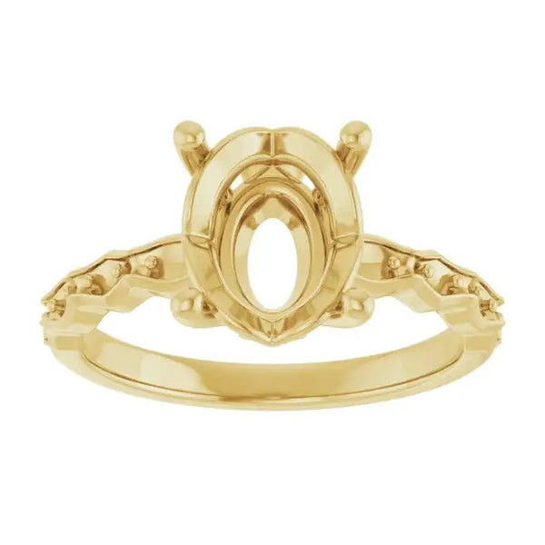 Gold engagement ring setting with oval stone center and diamond accents on shoulders, shown front view.