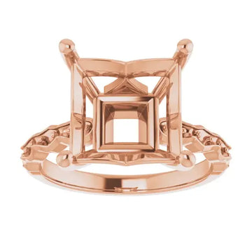 Rose gold engagement ring setting with square cushion-cut stone holder and decorative side accents.