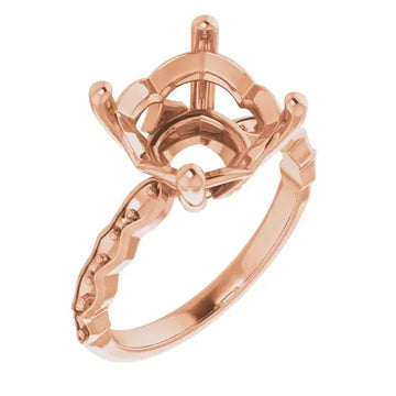 Rose gold engagement ring setting with ornate cushion-cut stone holder and decorative beaded band.