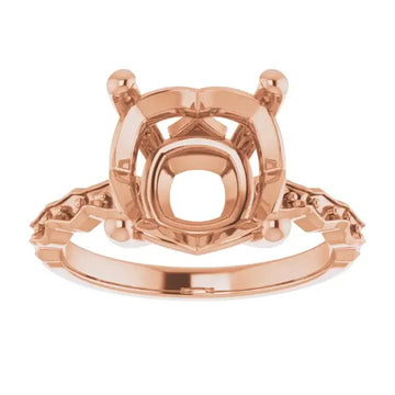 Rose gold engagement ring setting with French-set prongs, cushion stone center, and decorative shoulders, shown from front vi