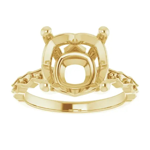 Gold engagement ring setting with French-set side stones and cushion-cut center stone mounting.