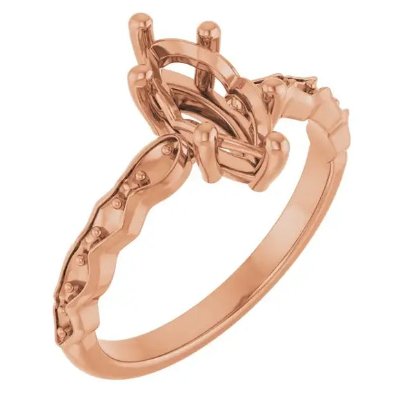 Rose gold engagement ring setting with French-set side stones and marquise-shaped center stone holder.