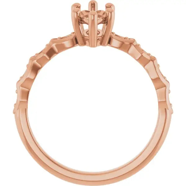 Rose gold engagement ring setting with French-set stones along the band and open marquise-shaped prong head.