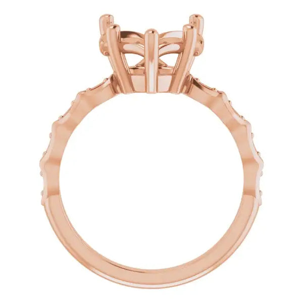 Rose gold engagement ring setting with geometric heart-shaped stone holder and accent stones along band.
