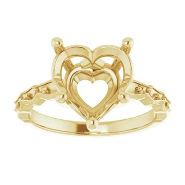 Gold engagement ring setting with nested heart-shaped frames and side stone settings, shown from above.