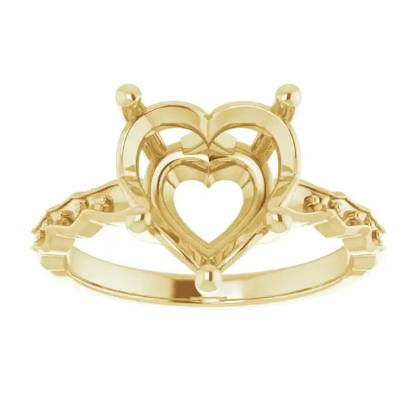 Gold engagement ring setting with nested heart-shaped frames and side stone settings, shown from above.