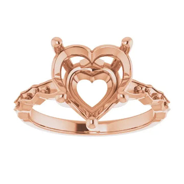 Rose gold engagement ring setting with nested heart-shaped center stone mount and decorative side shoulders.