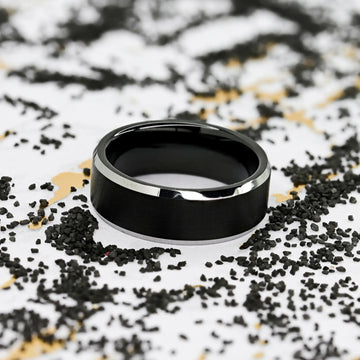 Close-up of interior comfort-fit profile of black brushed-center tungsten ring with beveled edges