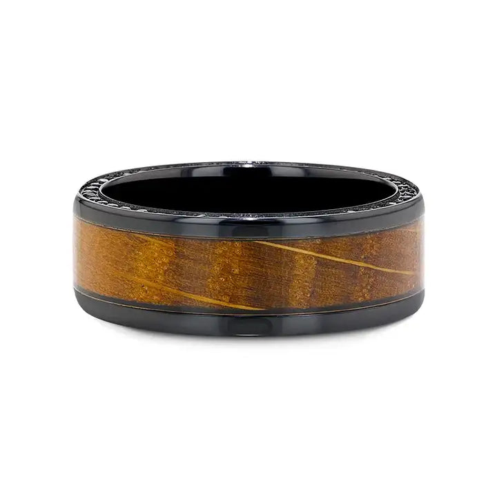 Flat lay of the ring highlighting the continuous whiskey barrel wood inlay framed by black zirconium and black sapphire accents.