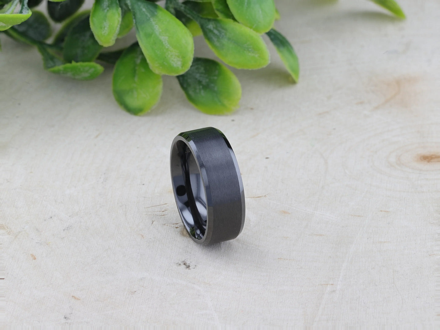 Interior view showing rounded comfort-fit inner shank of black titanium ring, 8mm