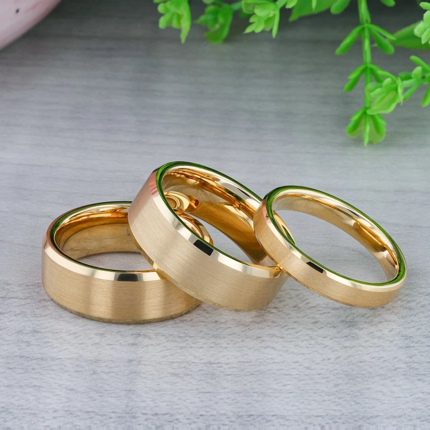 Gold-plated tungsten ring presented in a cream jewelry box, highlighting polished beveled edges.