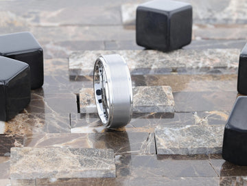 Close-up angled view of the OPTIMUS tungsten carbide ring interior engraving and brushed center