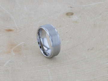 Side view close-up of the OPTIMUS tungsten carbide ring with brushed center and polished edges