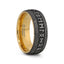 Angled view of an 8mm domed tungsten carbide wedding ring with matte black exterior, deep engraved Norse-style runes, braided border accents, and a polished gold-tone inner band