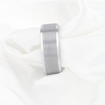 On-hand view of the Sheffield tungsten ring worn on a finger, showing its brushed center and polished beveled edge