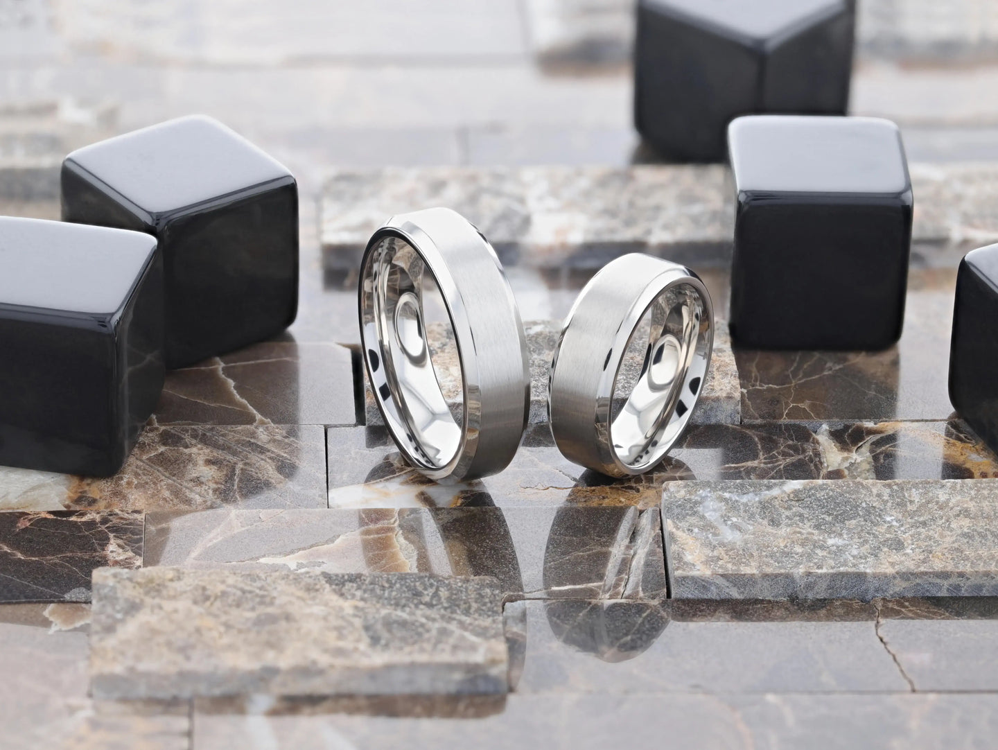Studio image of SHIRE titanium ring on display, brushed center detail