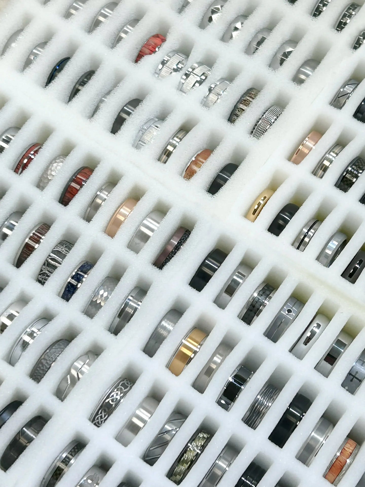 Collection of various rings on a white grid background