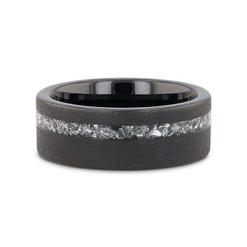 Top-down view of the ABYSS sandblasted black tungsten ring highlighting the meteorite fragments inlay and polished black interior
