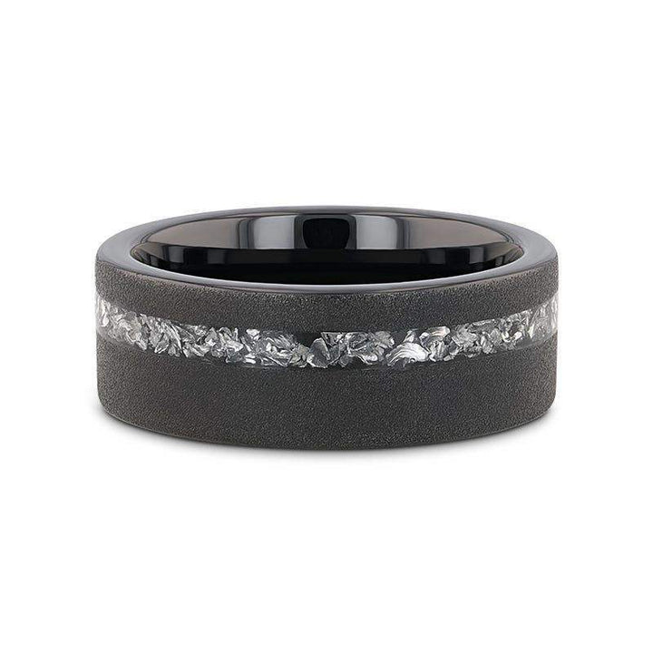 Top-down view of the ABYSS sandblasted black tungsten ring highlighting the meteorite fragments inlay and polished black interior