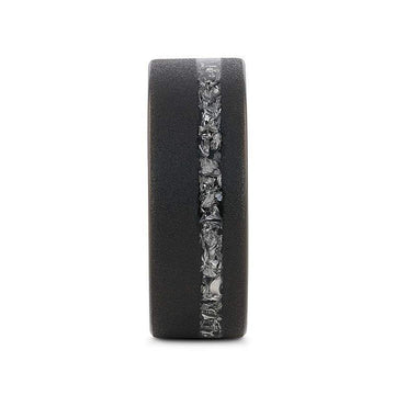 Front view showing the vertical band of meteorite fragments set into the sandblasted black tungsten ring