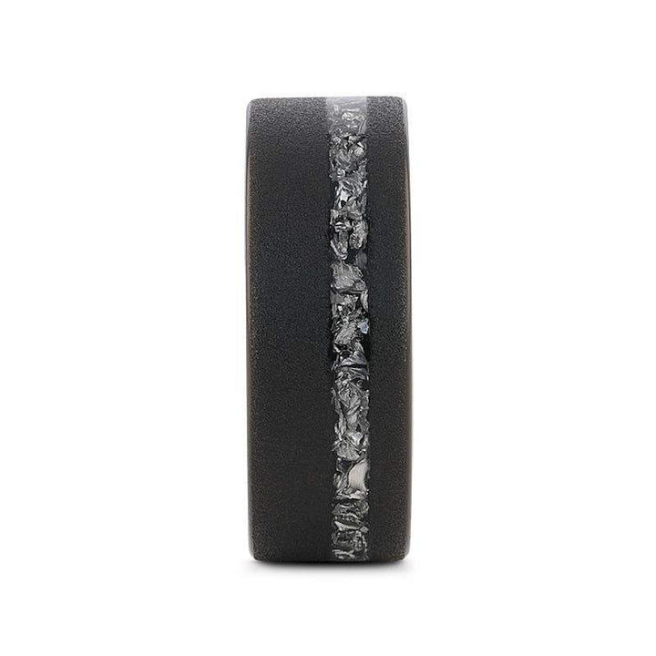 Front view showing the vertical band of meteorite fragments set into the sandblasted black tungsten ring